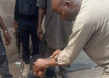 Kogi State administrator was pictured cutting the hair of a young man wearing dreadlocks