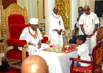 Oba Ewuare II Adopts 8-Year-Old Chess Prodigy, Pledges Royal Support  Reported by Musa Antiketu,| Journalist at Obaland magazine.  BENIN CITY, Edo State — The Oba of Benin, Oba Ewuare II, has pledged royal support for eight-year-old chess player Emmanuela Iyobosa Omoragbon, declaring her a child of the palace and directing officials to monitor her education, welfare and progress in the game.  The monarch made the announcement  during the opening of the Royal Rapid Chess Classic 2026 at the Benin Palace. He performed the ceremonial first move alongside the young player at the event organised as part of activities marking the 10th anniversary of his coronation.  Oba Ewuare II instructed palace chiefs in the administrative arm to obtain the child’s details from her mother, Mrs Doris Omoragbon, a national chess champion and senior player with the Edo State Sports Commission.  The monarch said the palace would follow Emmanuela’s development in chess, education and general welfare, adding that her parents should inform him of any challenges requiring royal intervention.  Describing chess as a game that demands intellectual discipline, strategic thinking and concentration, the Oba said it was often misunderstood as similar to draughts. He explained that chess develops analytical skills, strengthens decision-making and encourages players to anticipate situations before acting.  According to the monarch, these qualities make the game particularly relevant to military leaders, policymakers and administrators, whose responsibilities require planning and sound judgment.  The gesture places renewed attention on the importance of identifying and supporting young sporting talents. Emmanuela, who plays chess with the Edo State Sports Commission, is a Primary Two pupil at Oman Christian Academy in Benin City.  Her mother expressed gratitude for the monarch’s intervention, saying she was overwhelmed by the announcement and would share the news with her husband and the rest of the family.  The report also stated that the monarch presented a royal gift of ₦250,000 to Mrs Omoragbon. Chess players and students from Edo College who visited the palace reportedly received a combined royal gift of ₦2 million. The Oba further promised a personal royal gift for Emmanuela.  The monarch also announced additional royal prizes for winners of the competition, who are expected to receive royal souvenirs at the grand finale scheduled for November 21, 2026.à  Following the palace ceremony, the tournament continued at the Victor Uwaifo Creative Hub on Airport Road in Benin City. Organisers reported that 126 of the 130 registered players attended, representing 10 states.  Participating states included Lagos, Rivers, Bayelsa, Delta, Oyo, Ondo, Ogun and host state Edo, alongside other participating states.  In the open category, the winner stands to receive ₦350,000, while the second- and third-place finishers will receive ₦250,000 and ₦150,000, respectively. Players finishing fourth to tenth will each receive ₦50,000. Additional ₦50,000 prizes have been allocated to the best Edo indigene and the best veteran player.  The under-20 category offers ₦100,000 for first place, ₦80,000 for second and ₦50,000 for third, in both the male and female divisions. In the under-14 category, the top three prizes are ₦30,000, ₦20,000 and ₦10,000, respectively. The under-10 category offers ₦25,000, ₦15,000 and ₦10,000.  Chess coordinator Augustine Apemiye thanked the Oba for including the game in the coronation anniversary programme. He disclosed that approval was being sought to establish the Oba Ewuare II Chess Club, which would provide children in the palace with opportunities to learn chess. He also offered to bring experienced chess champions to train them.  The proposed club could help extend access to chess training among young people in Benin City, although its establishment remains subject to the monarch’s approval.  Oba Ewuare II’s pledge to support Emmanuela highlights the potential role of traditional institutions in encouraging education, intellectual development and youth participation in sport. The tournament also provides a platform for players from different states to compete and develop their skills.  For Emmanuela, the royal commitment represents an opportunity to pursue chess alongside her education, with the palace promising to monitor her progress and welfare.  Tags: Oba Ewuare II, Emmanuela Omoragbon, Royal Rapid Chess Classic 2026, Edo State Chess, Benin Kingdom  Oba Ewuare II adopts eight-year-old chess player Emmanuela Omoragbon as a child of the palace, pledging support for her education, welfare and chess development during the Royal Rapid Chess Classic 2026.